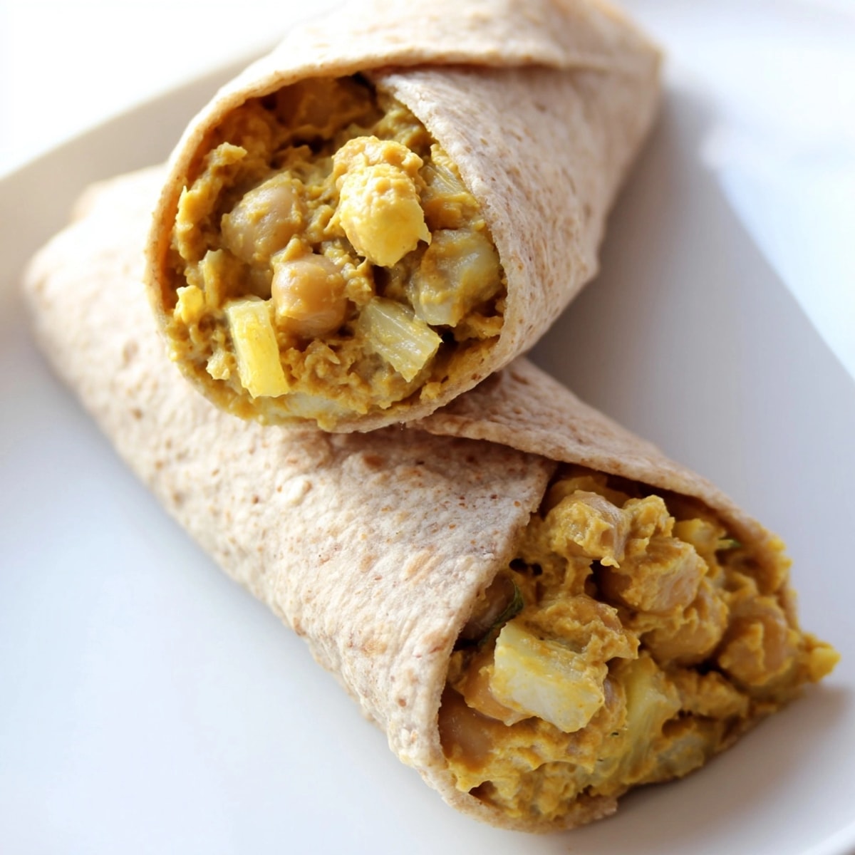 Savory Indian Spiced Chickpea Wraps filled with cool yogurt, pineapple, and vibrant seasonings.