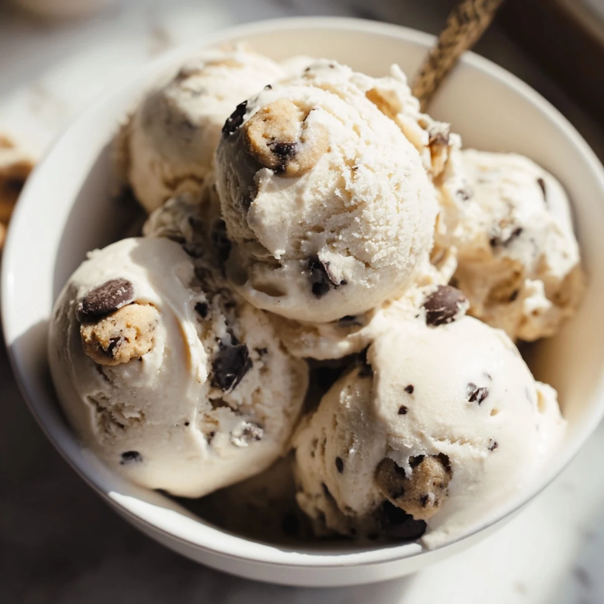 A delightful bowl of cottage cheese ice cream, swirled with sweet cookie dough bites.  