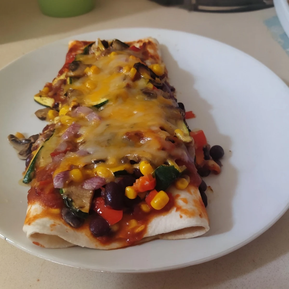 Farmers Market Vegetarian Enchiladas bubbling with cheese and a vibrant, freshly-cooked vegetable filling.