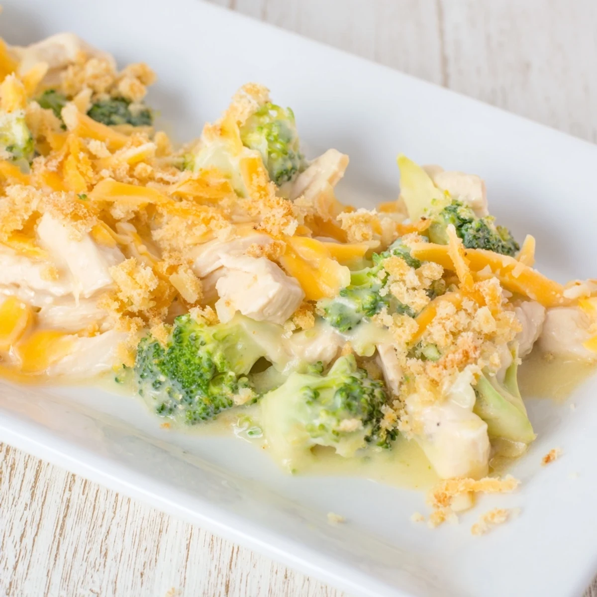 Golden and bubbly Chicken & Broccoli Cheddar Bake, ready for serving with melted cheese.