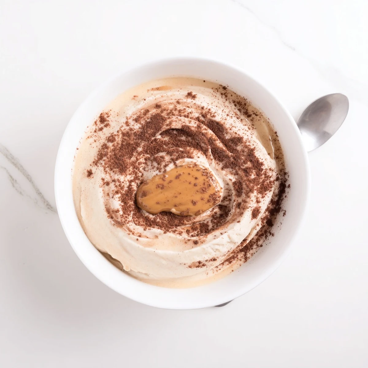 A close-up of Peanut Butter Banana Ice Cream, a simple frozen treat with a swirl of peanut butter.