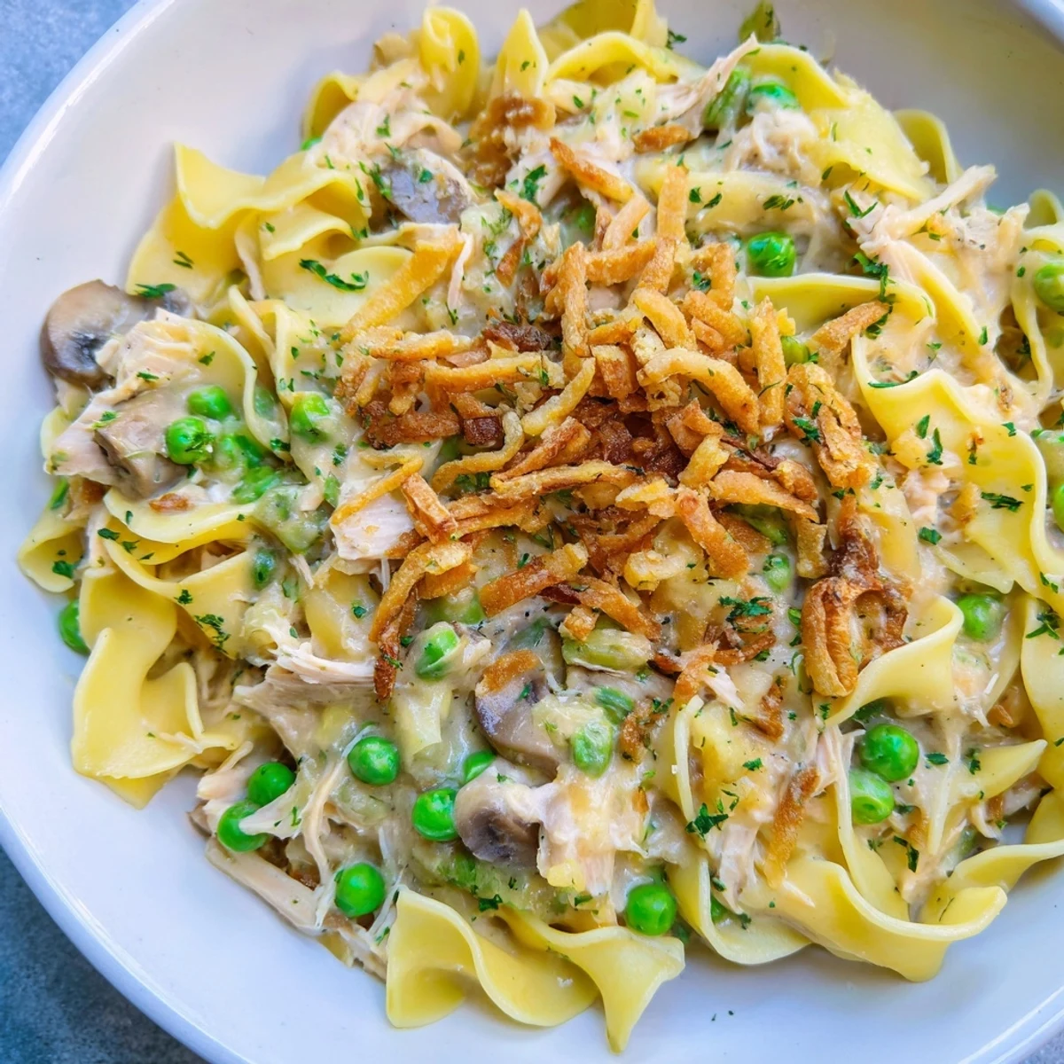The baked Creamy Tuna Noodle Casserole, a classic comfort food dish, smells savory and is ready to serve.