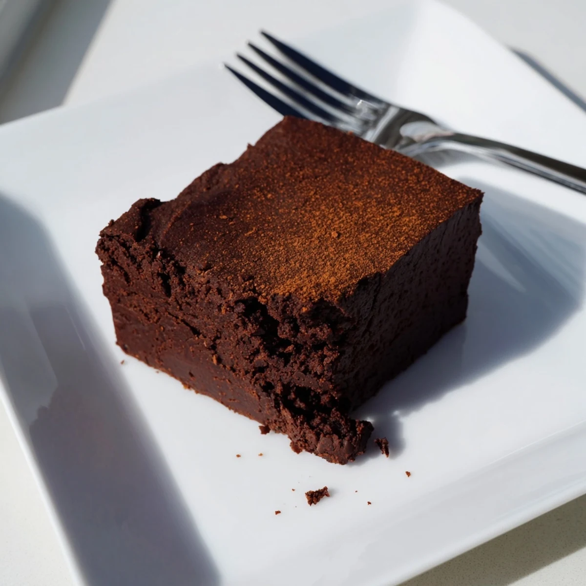 A square of these moist, dark Pumpkin Workout Brownies, offering a fudgy, chocolatey bite.