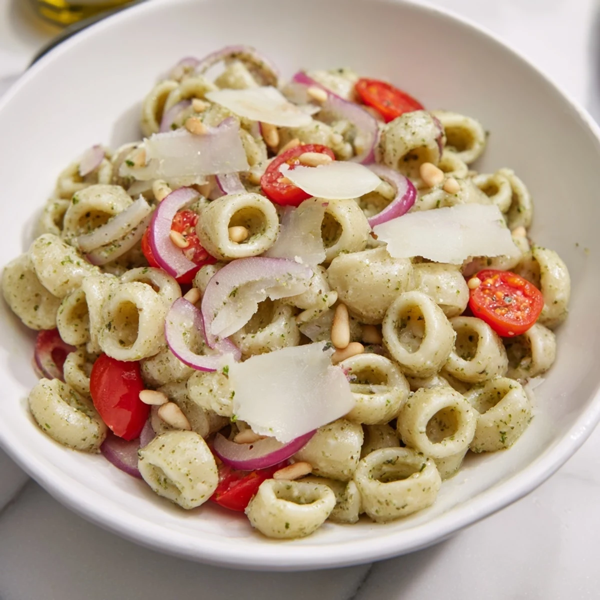 This vibrant Caesar Pesto Ditalini Salad boasts creamy pesto dressing over ditalini pasta with crunchy vegetables.