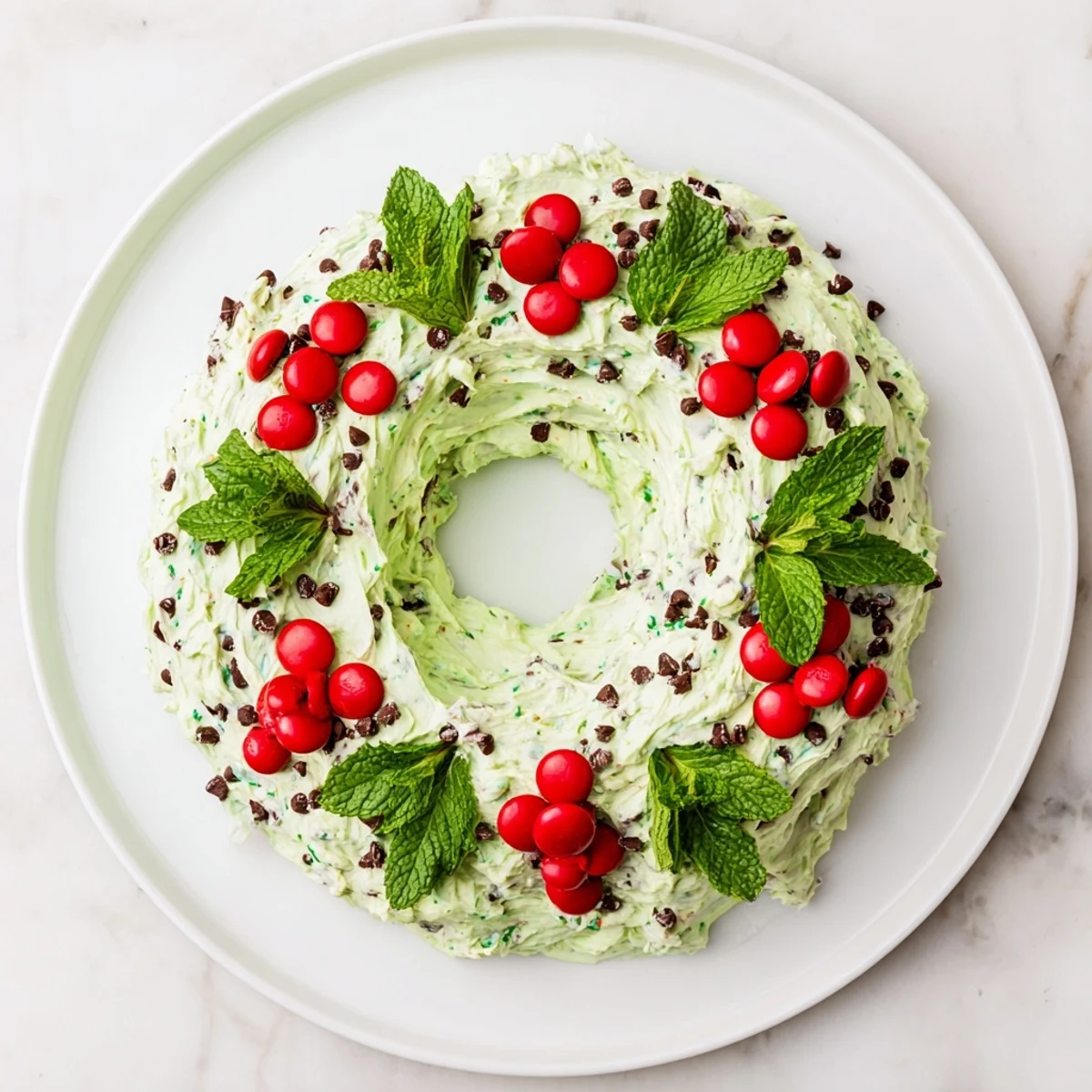 A beautiful holiday Mint Chocolate Chip Dip Wreath swirled and decorated for dipping cookies.