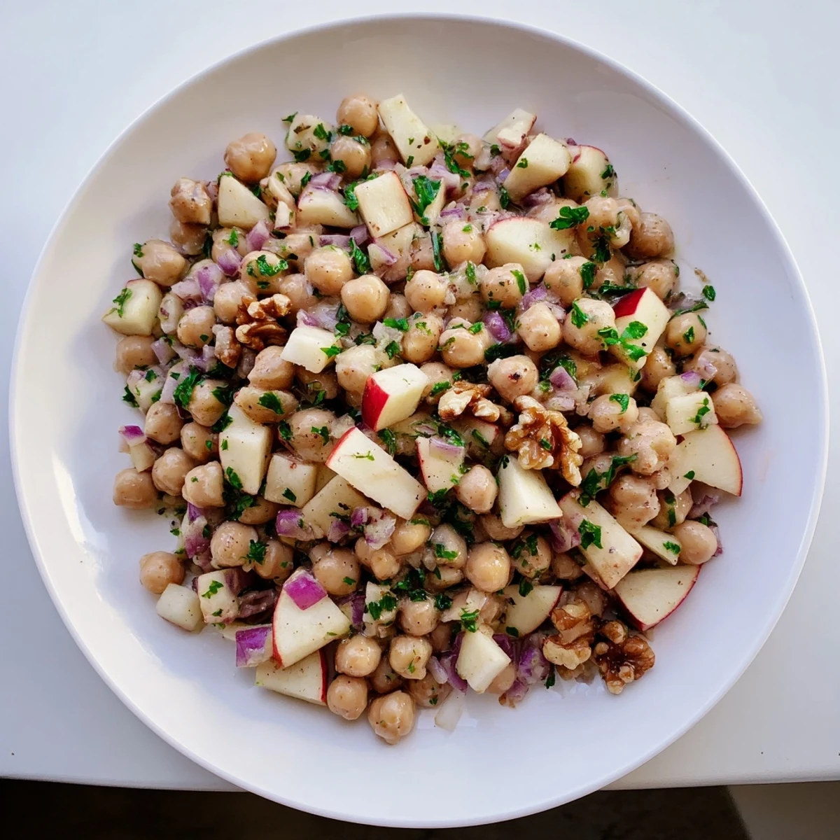 Freshly tossed Fall Harvest Apple and Chickpea Salad featuring crisp apple pieces and a creamy dressing, delicious!