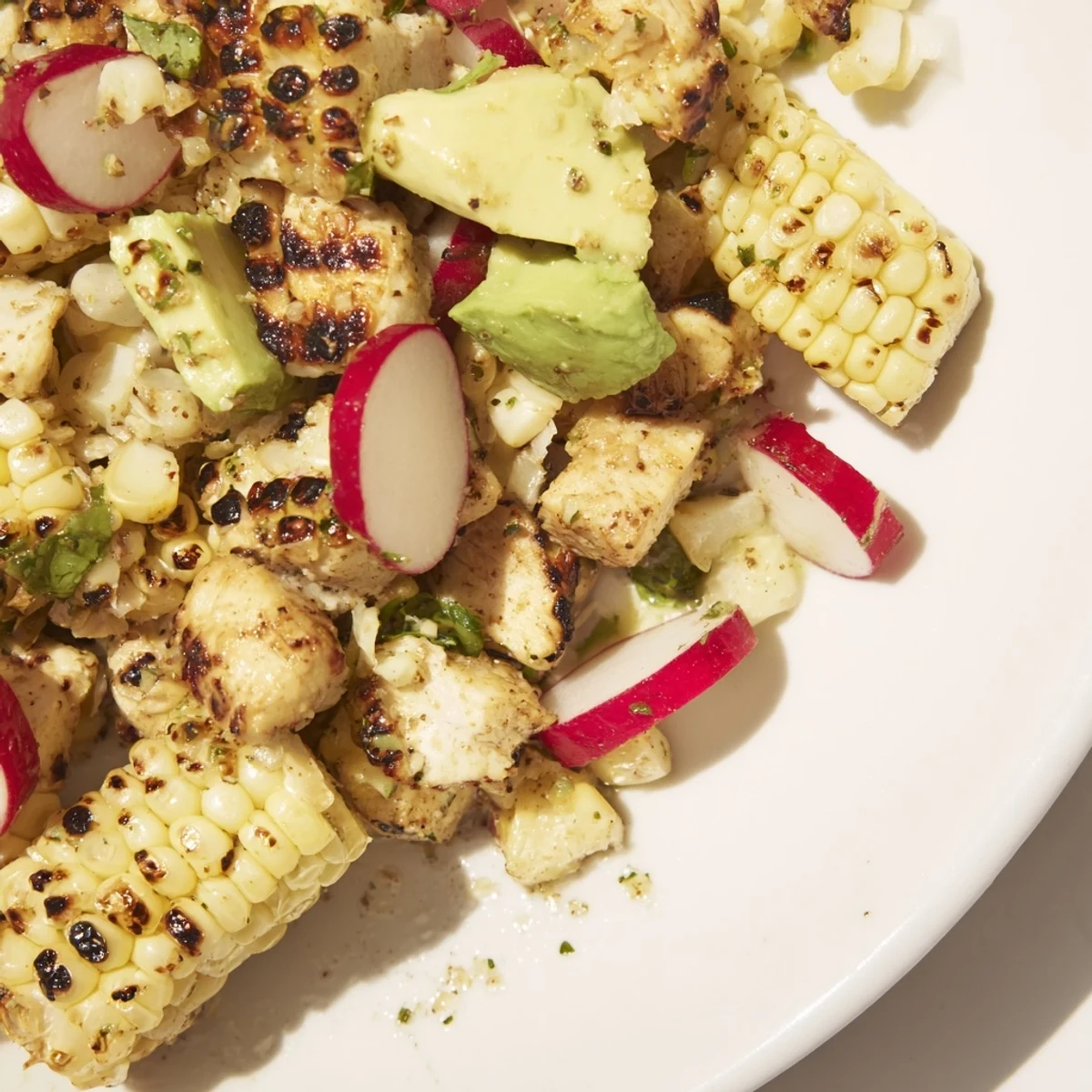 Charred grilled corn and juicy diced chicken on crisp romaine with creamy avocado and radishes in a zesty lime dressing.  
