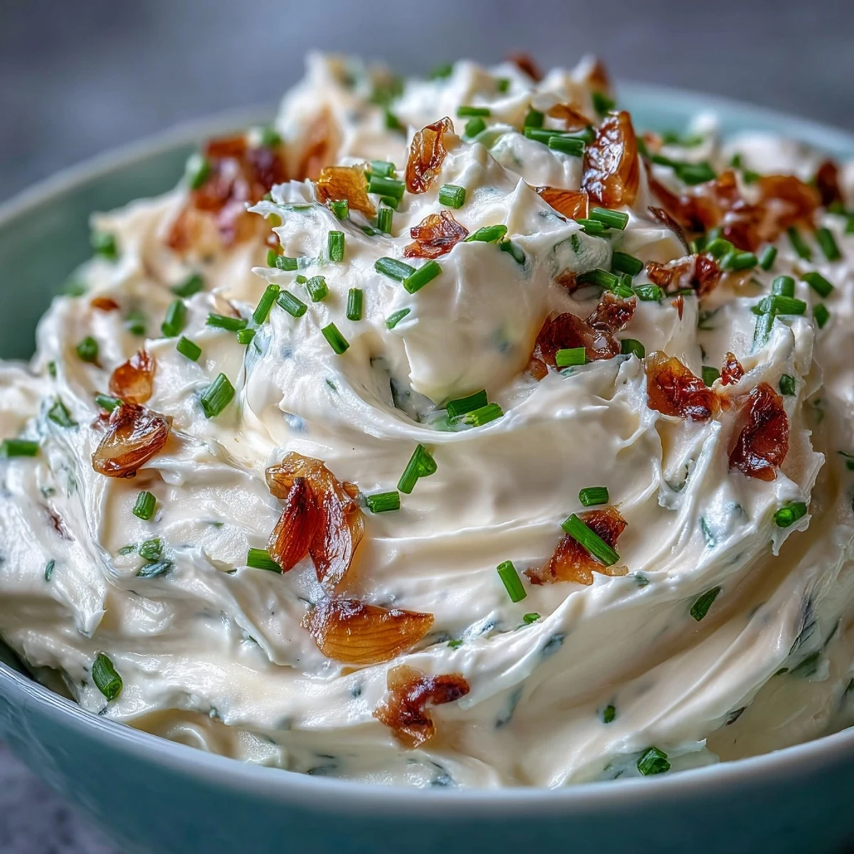 2. Velvety cream cheese blend infused with sweet roasted garlic, garnished with fresh chives, ideal for crudités or toasted bread.  