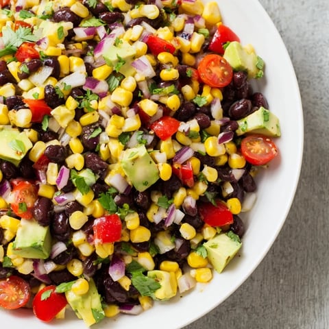 Vibrant Southwestern black bean and corn salad, a colorful mix with a zesty lime-cilantro dressing.
