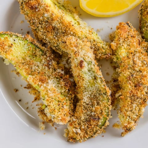 Golden, crispy baked avocado fries served fresh with bright lemon wedges and dipping sauce.