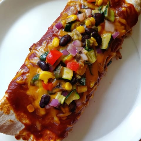 Delicious cheesy Farmers Market Vegetarian Enchiladas, baked and ready to serve with fresh cilantro garnish.
