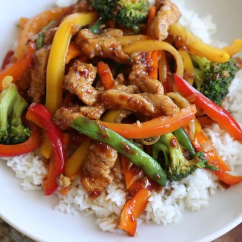 Tender chicken and vibrant vegetables shine in this delicious Chicken Stir-Fry meal photo.
