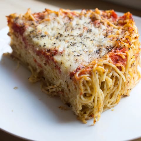 This delicious, comforting Cacio e Pepe Pasta Pie presents a satisfying, sliceable Italian treat ready to serve.
