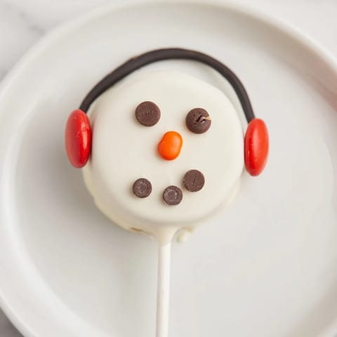 Look at these festive Budget-Friendly Oreo Snowman Pops, decorated with chocolate and sprinkles.