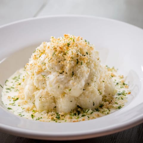 A close-up of a delightful Lightened Mac & Cheese Snowflake Pasta Bake with parsley sprinkled on top.
