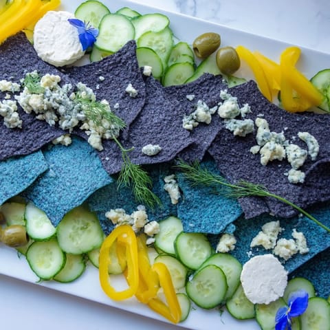 Delectable Deep Sea Ocean Wave appetizer with blue corn chips and a mix of fresh green ingredients, ready to serve.