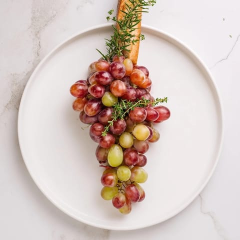 A vibrant display of vineyard grapes on a platter, perfect for a wine tasting soiree.