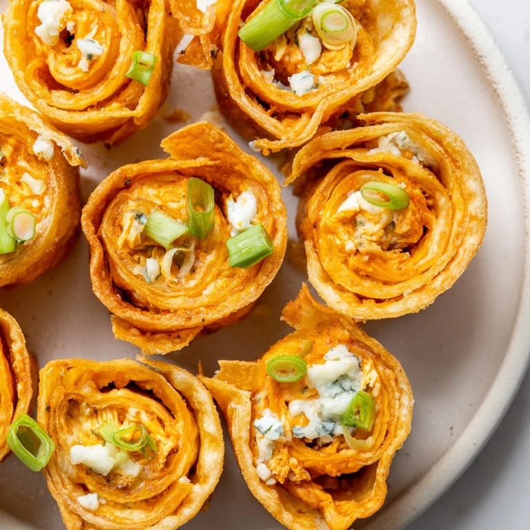 Imagine the aroma: hot, crispy Buffalo Chicken Dip Pinwheel Wontons, a crowd-pleasing snack everyone loves.