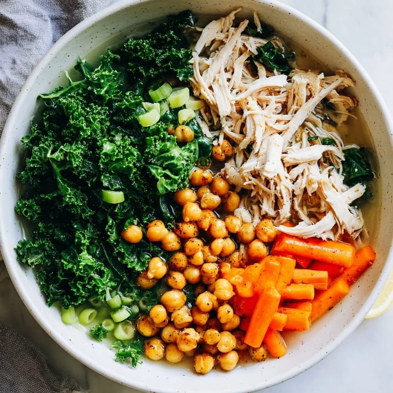 Savory Chicken Kale Soup featuring tender chicken and vibrant kale, with a delicious crispy chickpea topping.