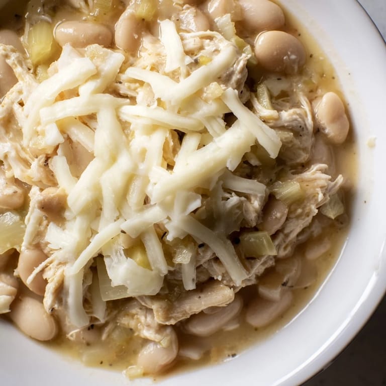 A close-up of a warm, savory bowl of 35-Minute White Cheddar Apple Chicken Chili, ready to enjoy.