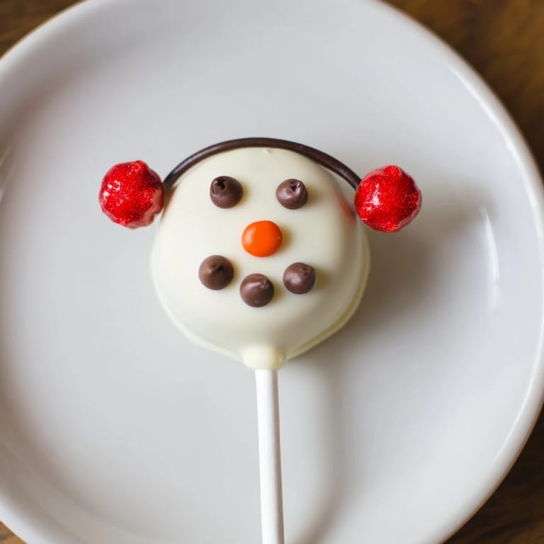 These homemade Budget-Friendly Oreo Snowman Pops feature cute candy decorations, ready to eat!
